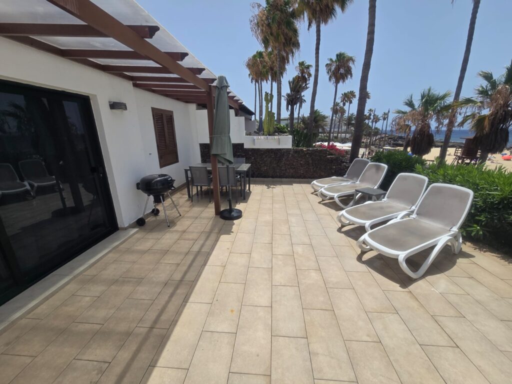 15 Playa Flamingo terrace with sun loungers and dining area