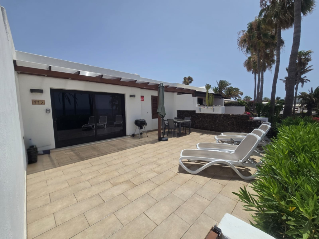 15 Playa Flamingo terrace with sun loungers and dining area